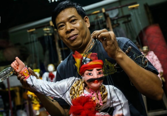 Khin Maung Htwe poses with puppet U Min Kyaw, one of the famous pantheon of 37 spirits, who is fond of drinking and merrymaking